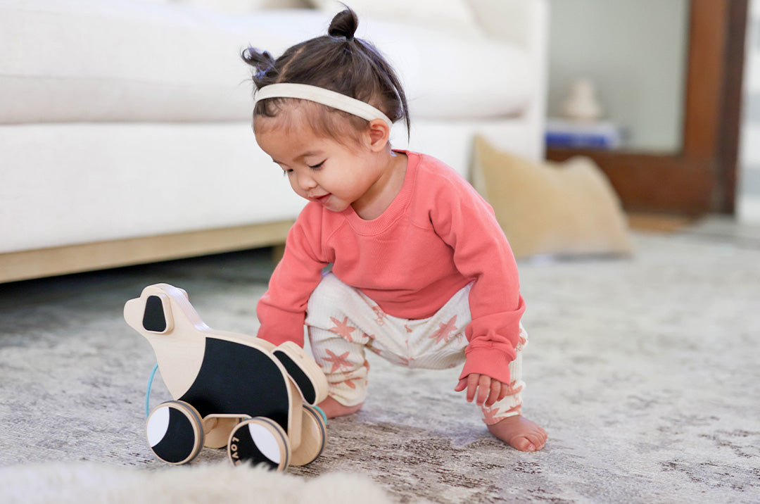a child playing in a flexible, collapsible tunnel